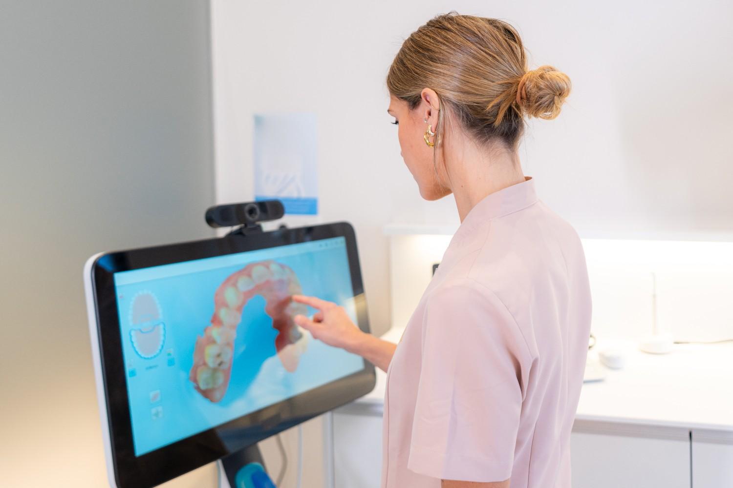 Dentist reviewing a digital smile design on a dental screen