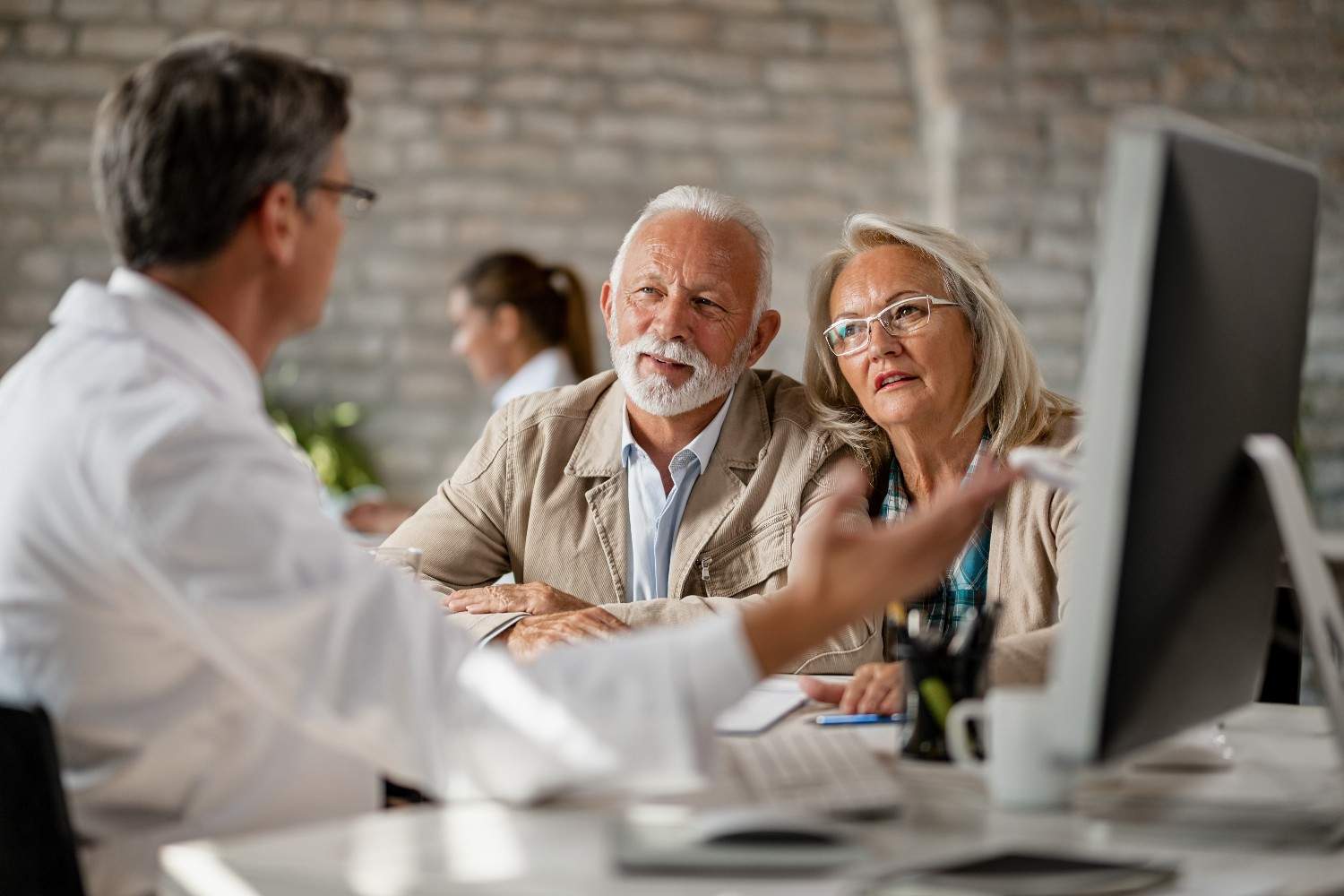 Dentist consulting with an older couple