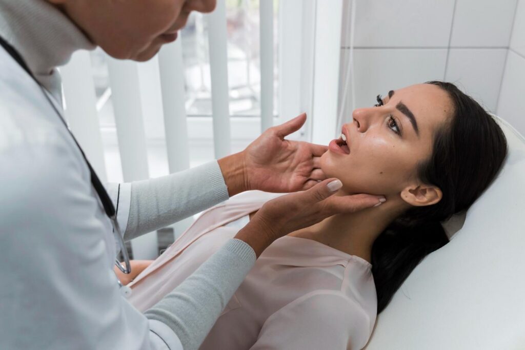 Dental professional examining a woman’s jaw