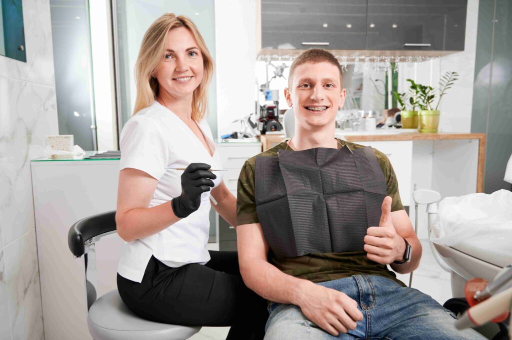 Smiling patient giving a thumbs up after treatment.