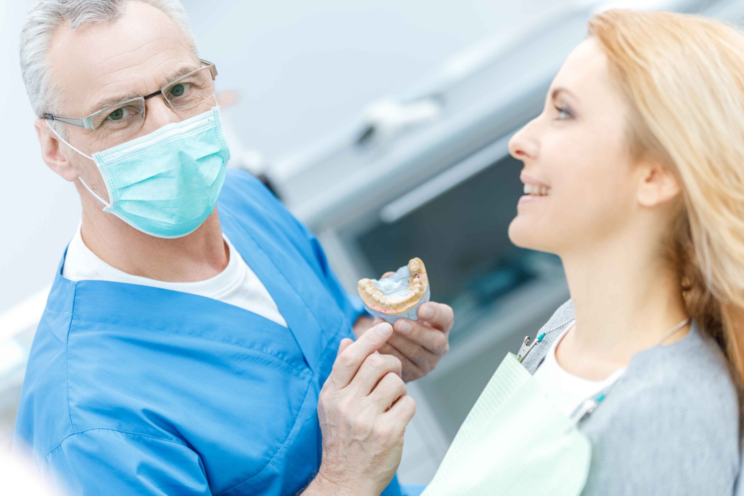 Dentist explaining dentures to a patient.