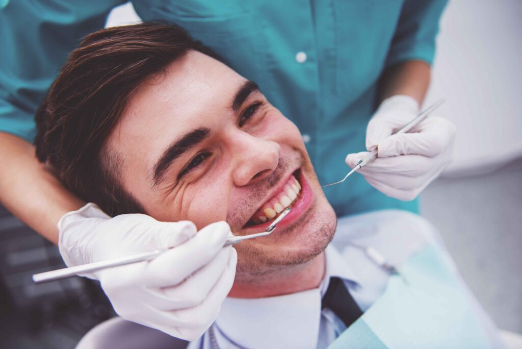 Dentist examining a patient's teeth during a dental checkup.